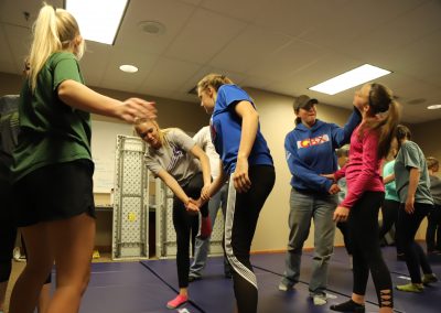 Students practice hands-on self defense
